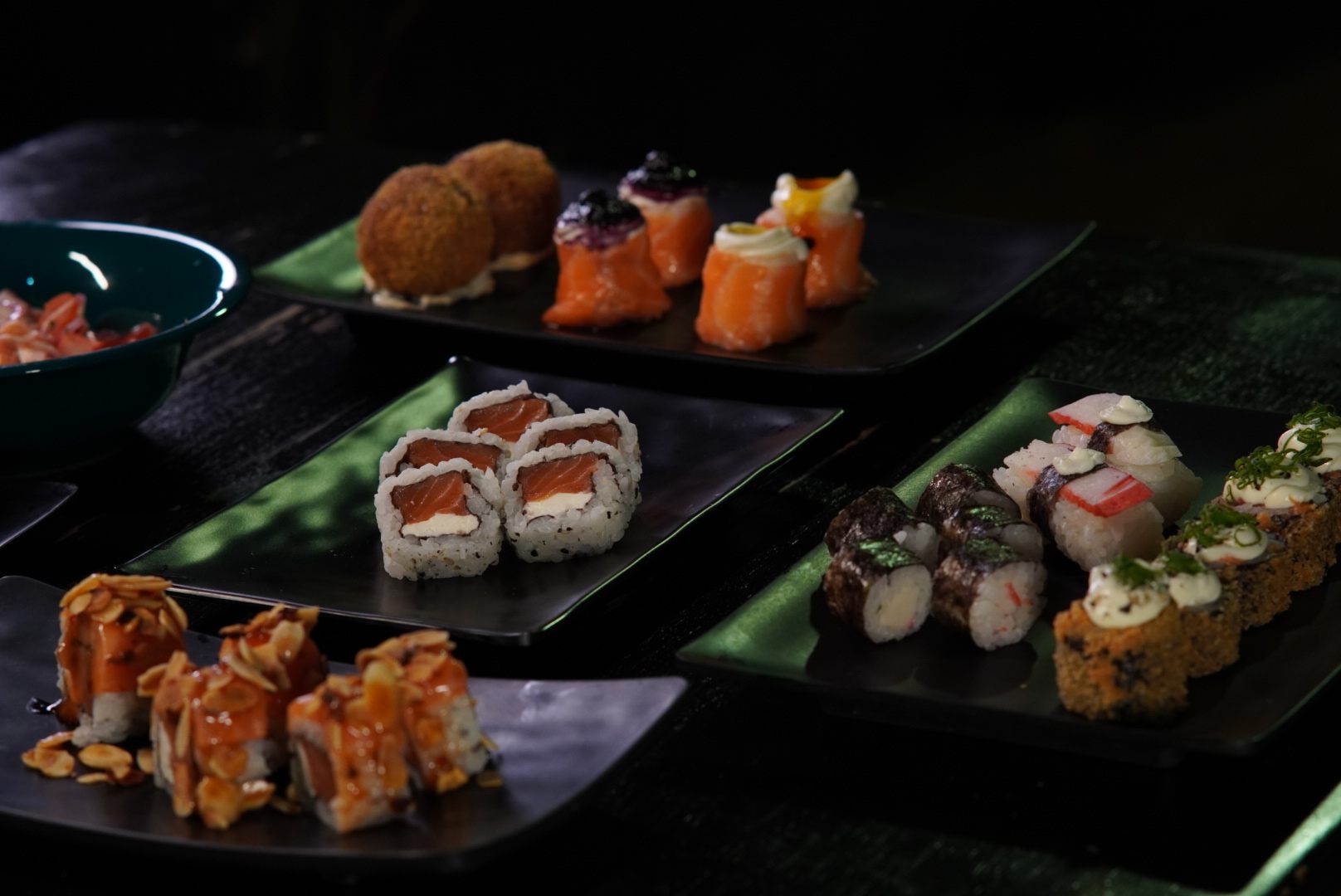 Seleção de sushis em pratos pretos